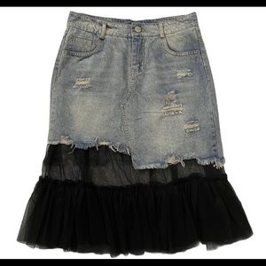 Denim skirt with black tooling.